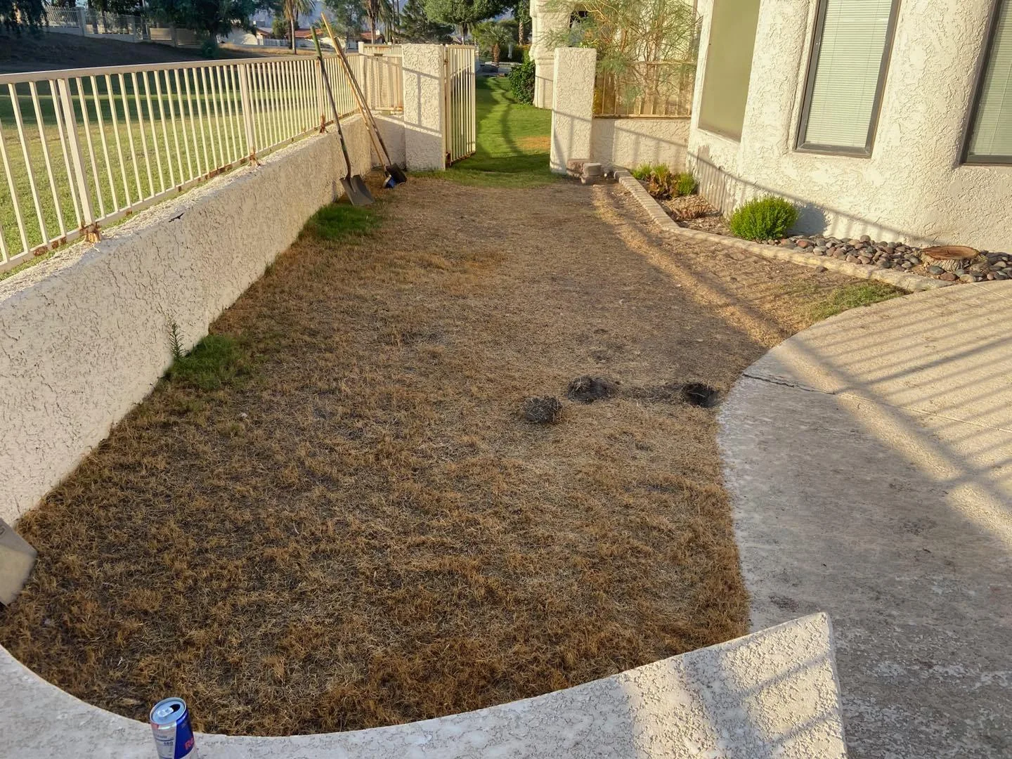 A failing DIY retaining wall showing bowing and cracks due to poor drainage and hydrostatic pressure